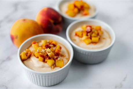 Peach mousse served in small white cups