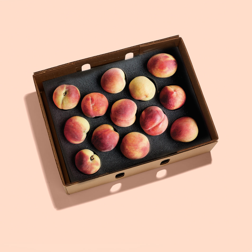 Box of peaches with its top removed